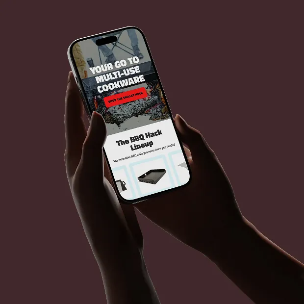 BBQ Hack hero on mobile device being held by shadowy hands