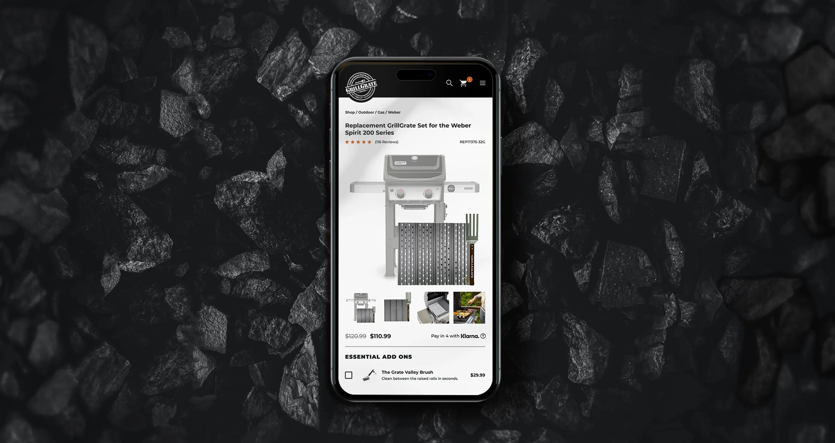 GrillGrate product page on a cell phone with charcoals in the background
