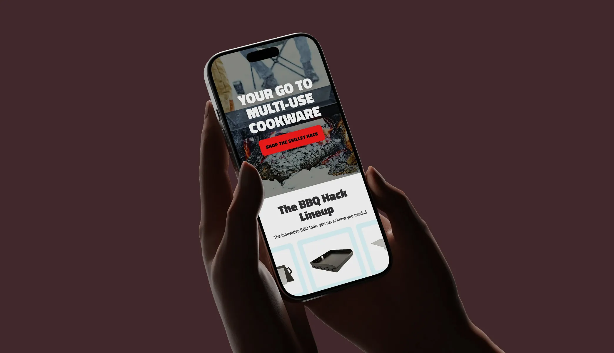 Hand holding a phone with a mockup of BBQ Hack's website