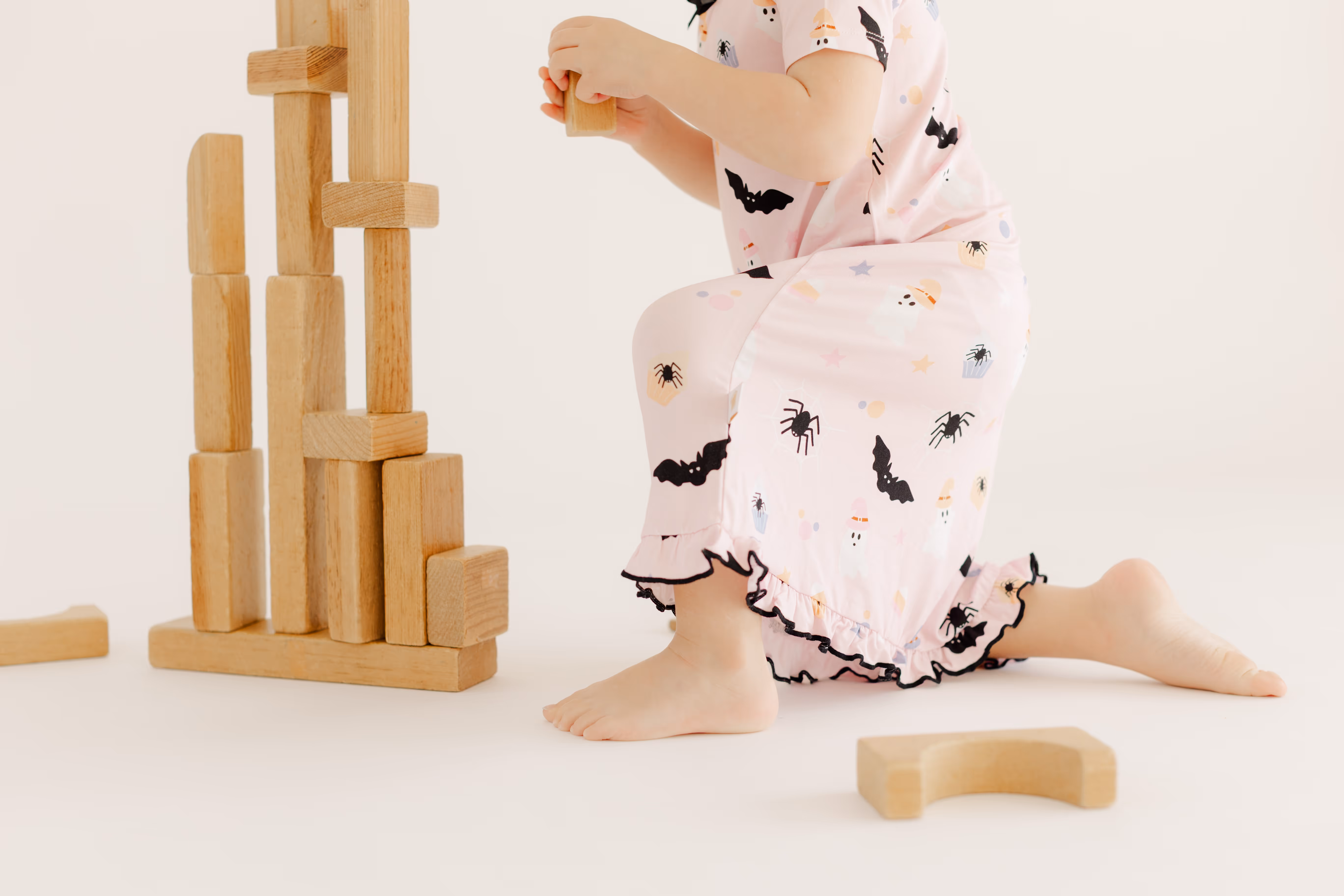 A child playing with blocks in front of a white backdrop at Brightroom Studio.