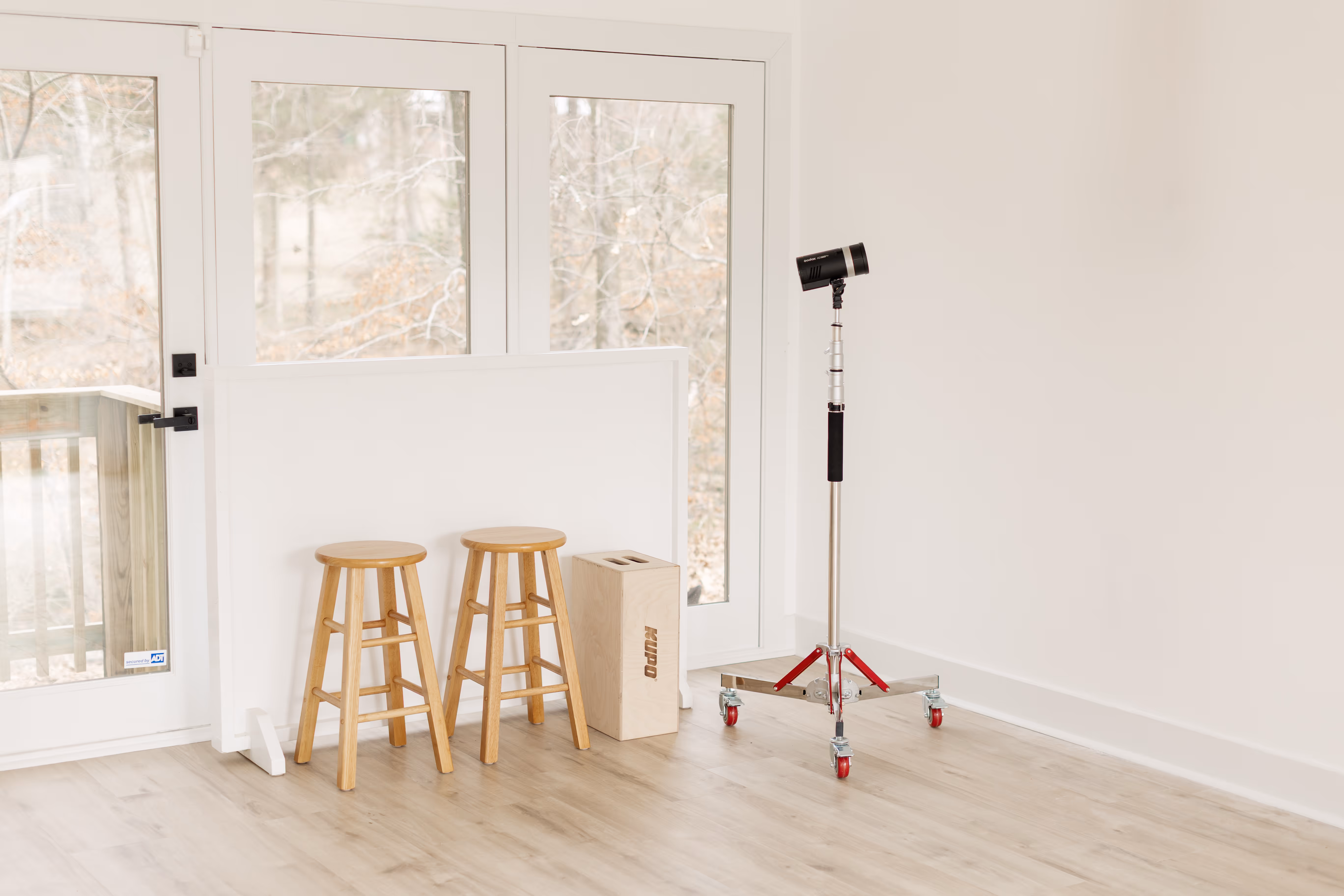 Professional lighting equipment and chairs at Brightroom Studio.