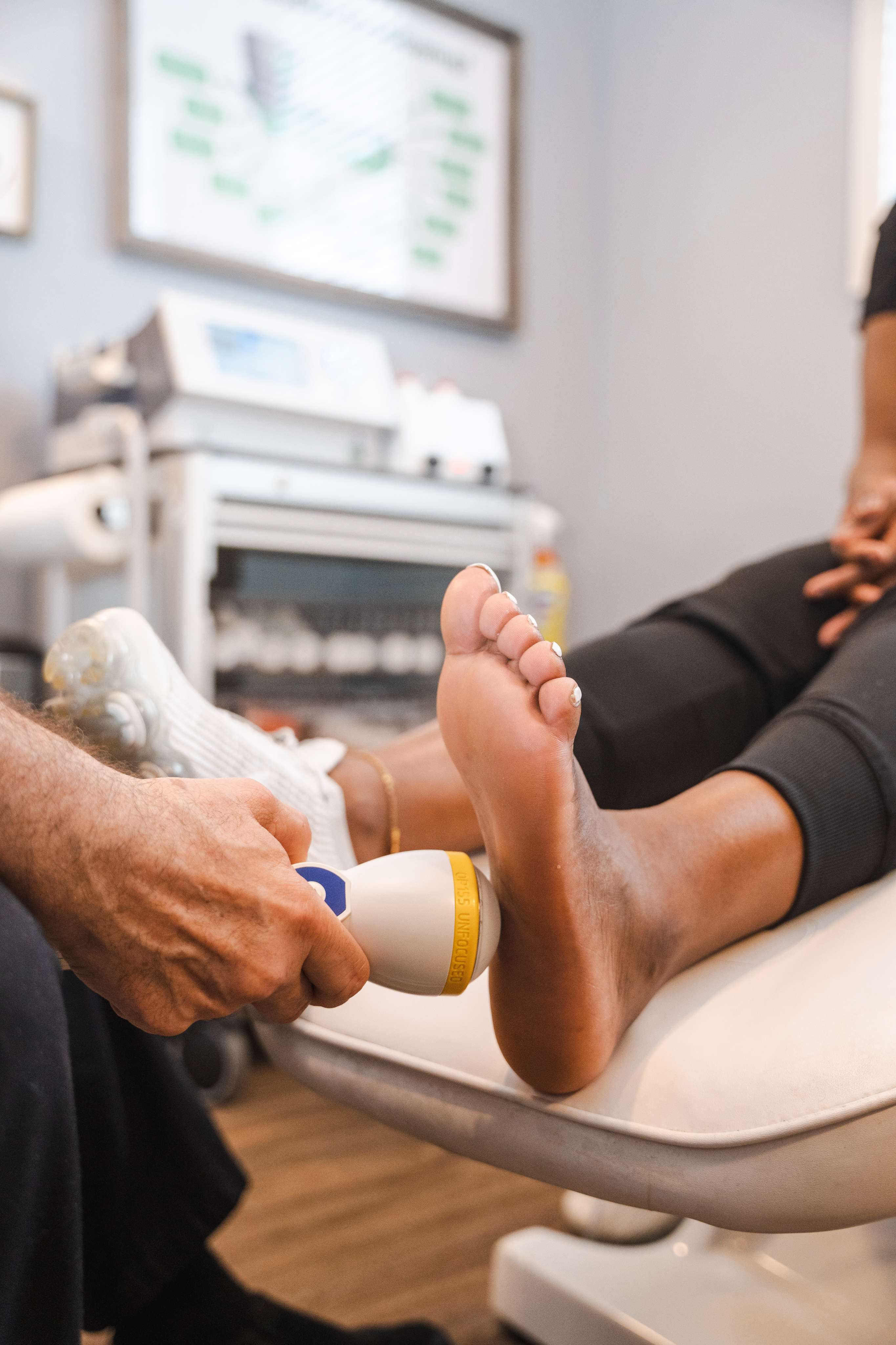 professional using Softwave on a patient's heel