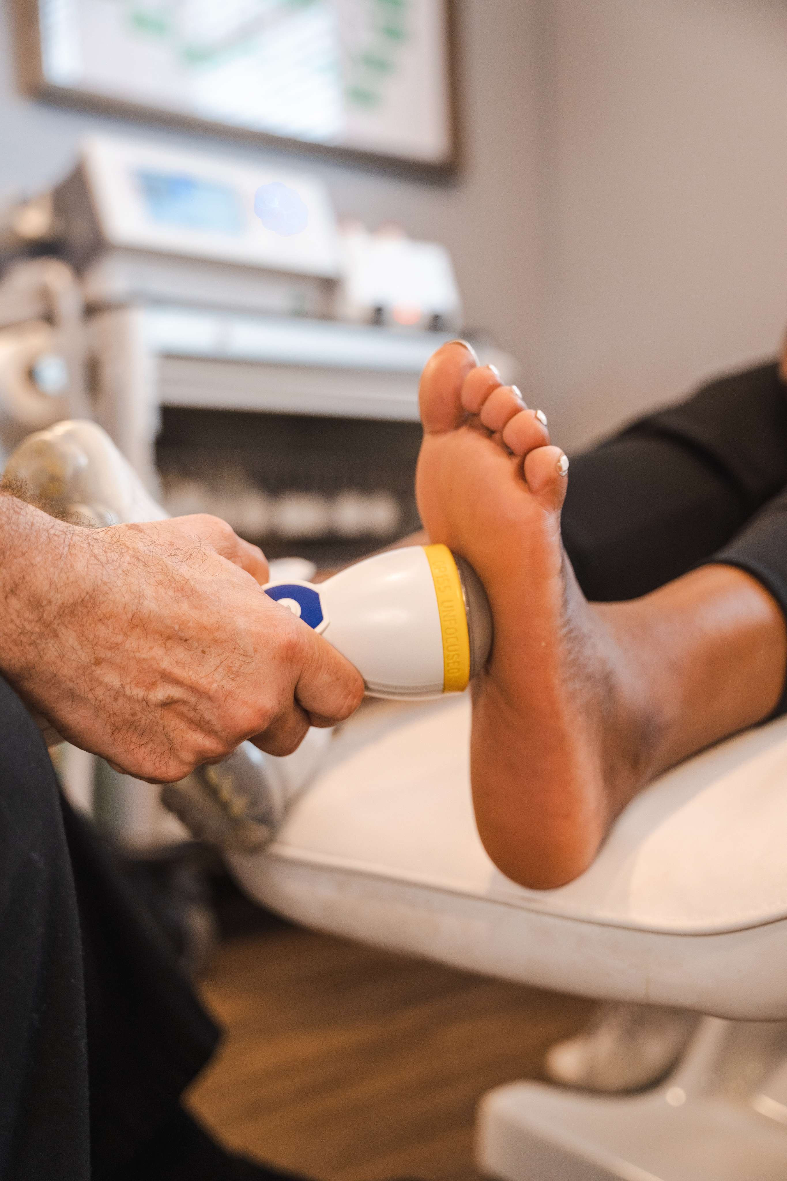 professional using Softwave on a patient's heel