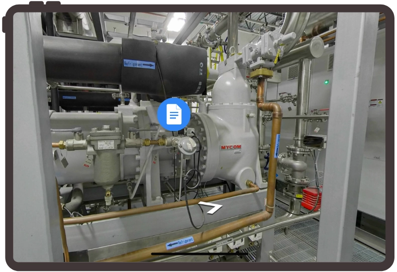 Modern living room with gray sofas, a large marble coffee table, floor lamp, wall-mounted TV, and a dining area with pendant lights in the background.