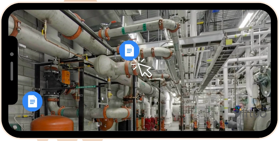 Industrial mechanical room with large pipes, valves, and equipment under a metal ceiling.