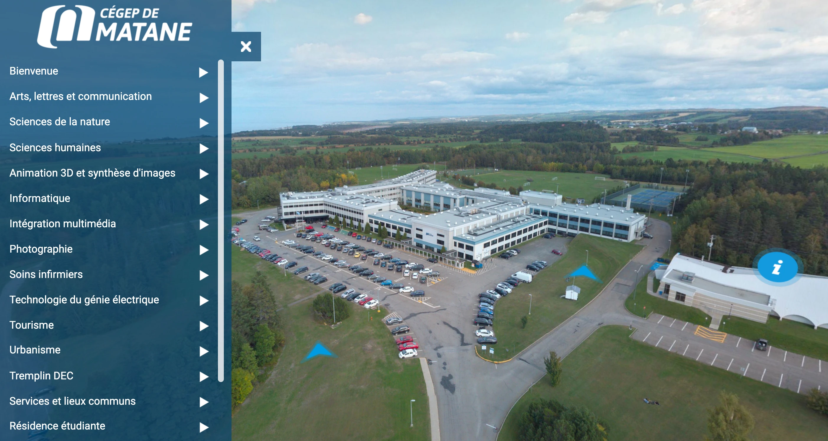 Aerial view of Cégep de Matane campus with parking lots, green fields, and surrounding trees under a partly cloudy sky.