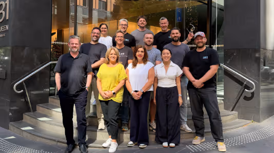 Neo team standing together outside their office building