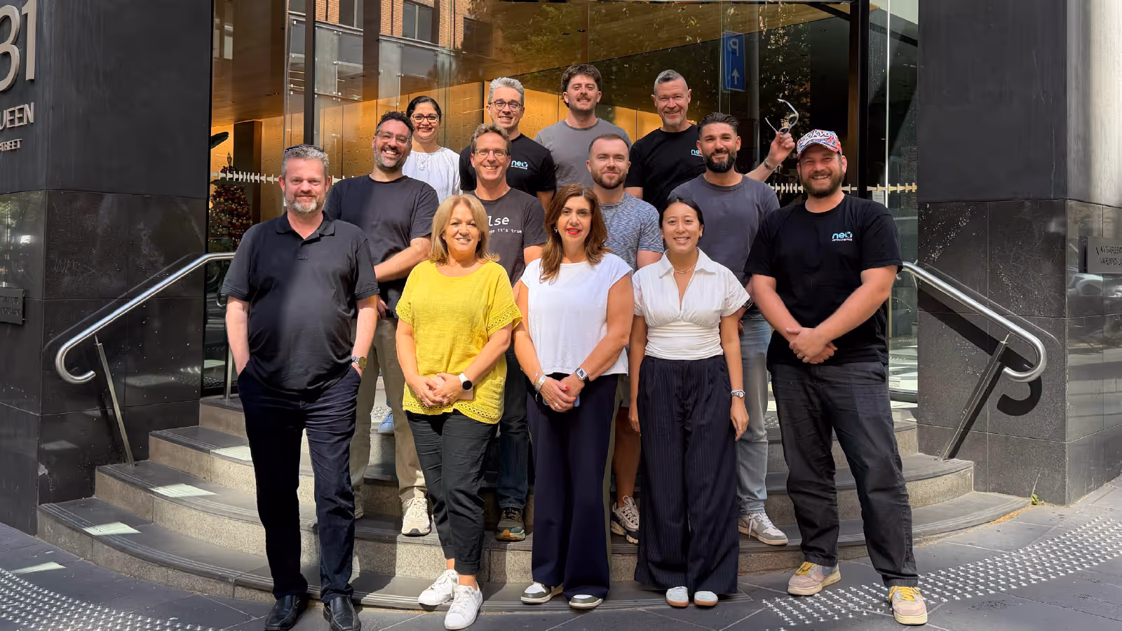 Neo team standing together outside their office building