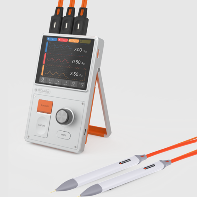 MX Meter device with screen displaying voltage, current, and power waveforms, connected to two white probes with orange cables.