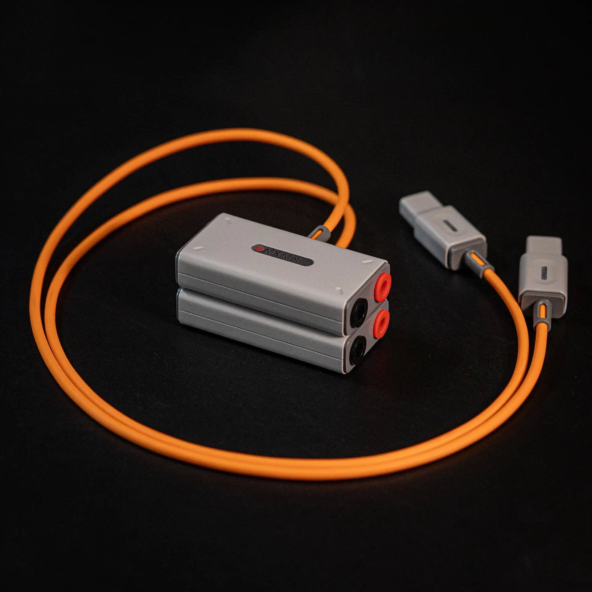 Two matching electrical test probes with pointed metal tips, one with a red accent and one with a black accent.