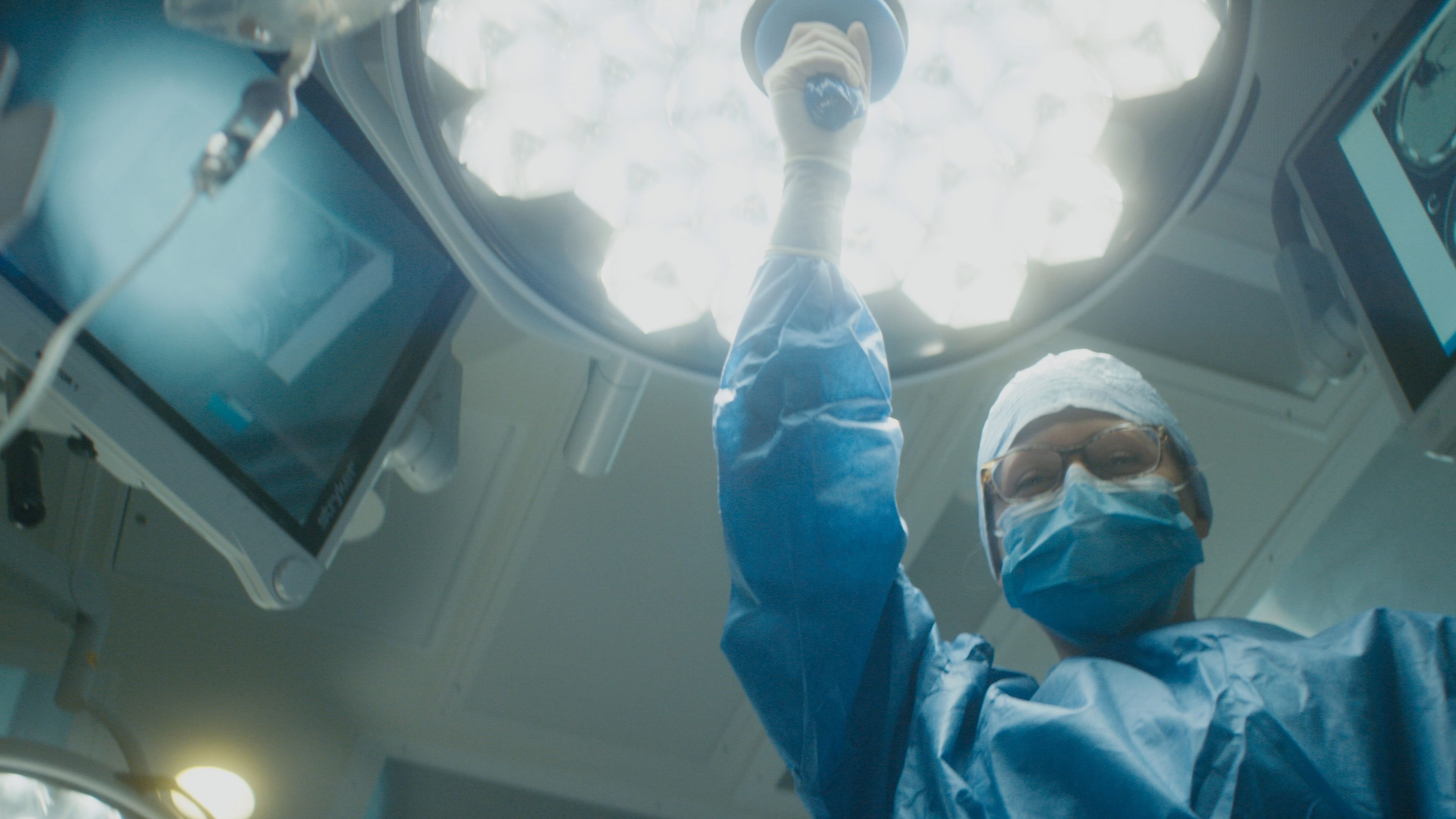 Surgeon moving overhead light
