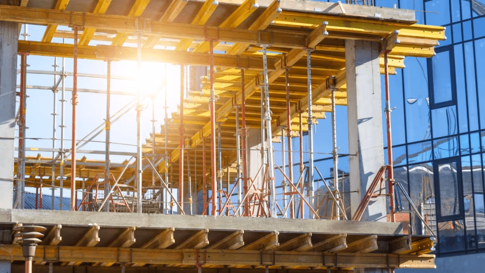 construction site with the framework of the second level and sun shining through