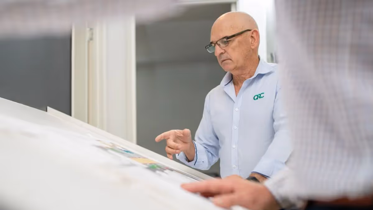 QRC Managing Director Chris Jones discussing construction plans with colleague