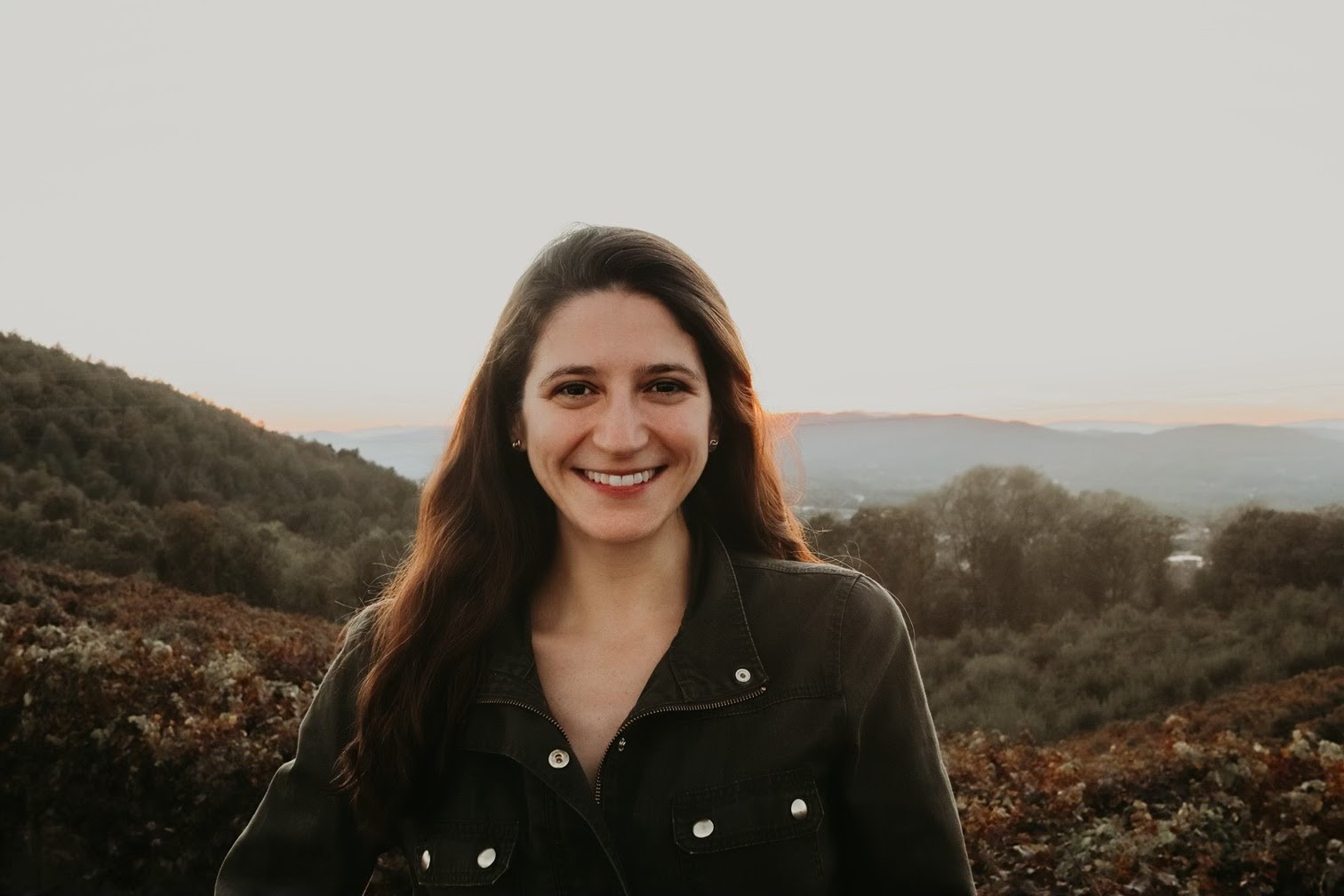 Hand wearing a blue glove pointing at a dental X-ray showing teeth and jawbone with braces.
