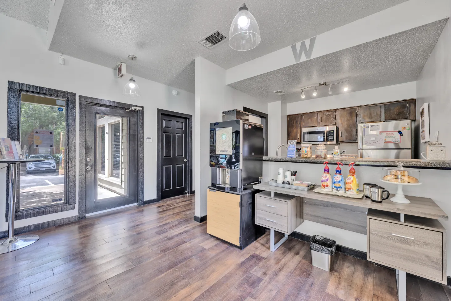 community kitchen with coffee bar table with bagels