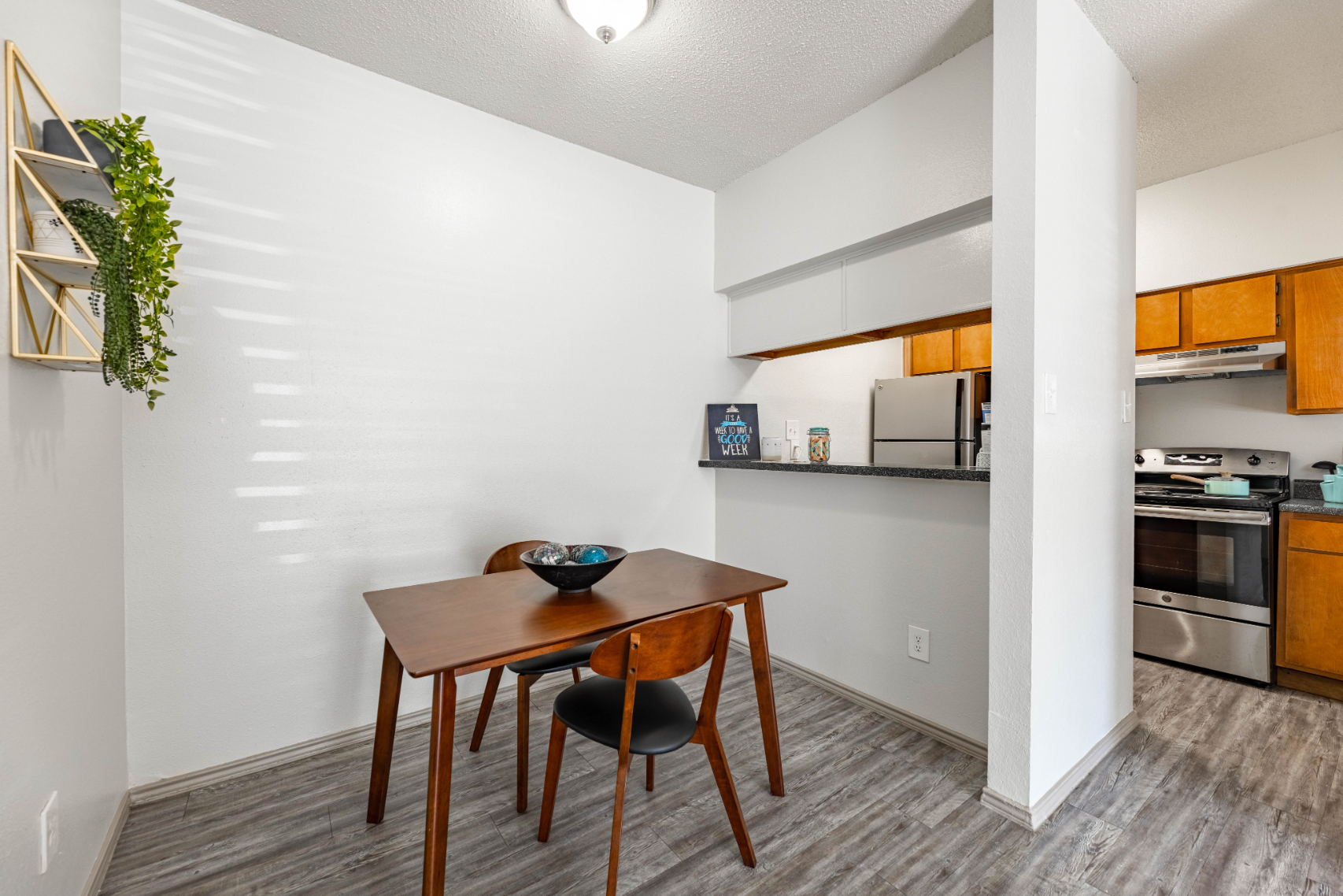 view of dining area with table and chairs and kitchen with stainless steel appliances