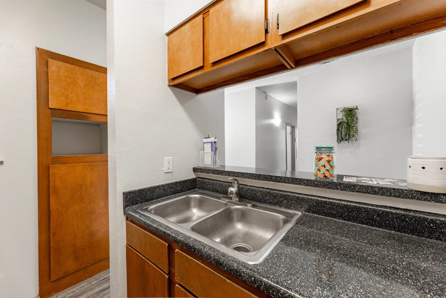 kitchen with stainless steel sink and brown cabinetry 