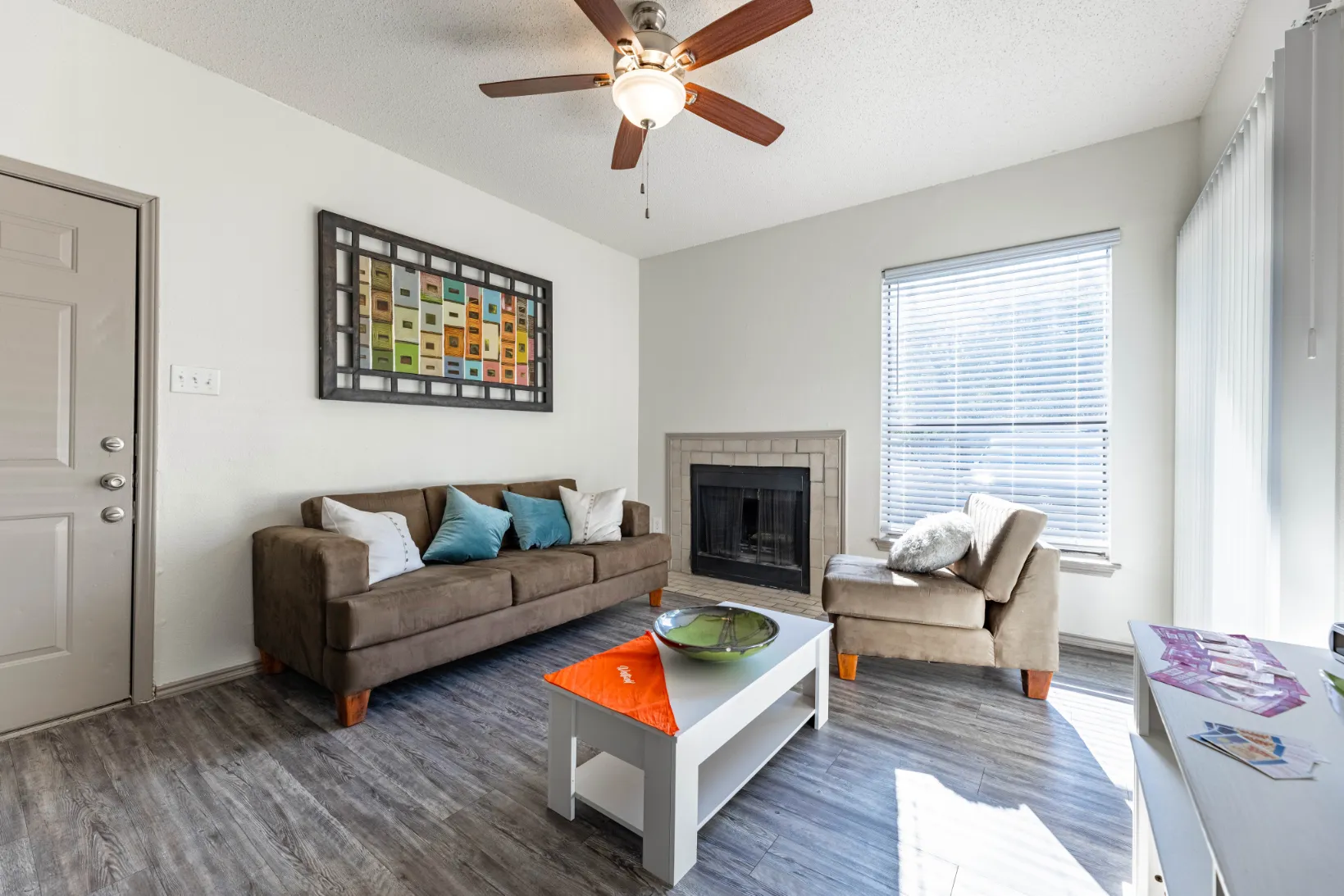 living area with sofa, coffee table and fire place