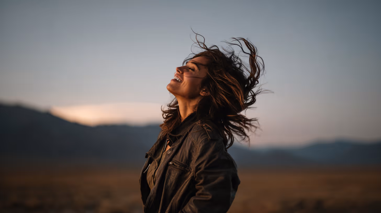 Abstract pattern of elongated purple and red dots fading into an orange background.