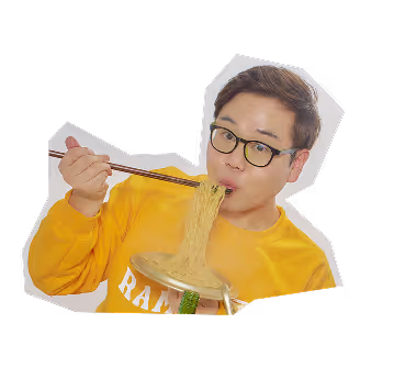James wearing glasses and a yellow sweatshirt eating noodles with chopsticks from a bowl.