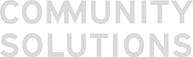 Text logo reading 'COMMUNITY SOLUTIONS' in large, bold gray letters.