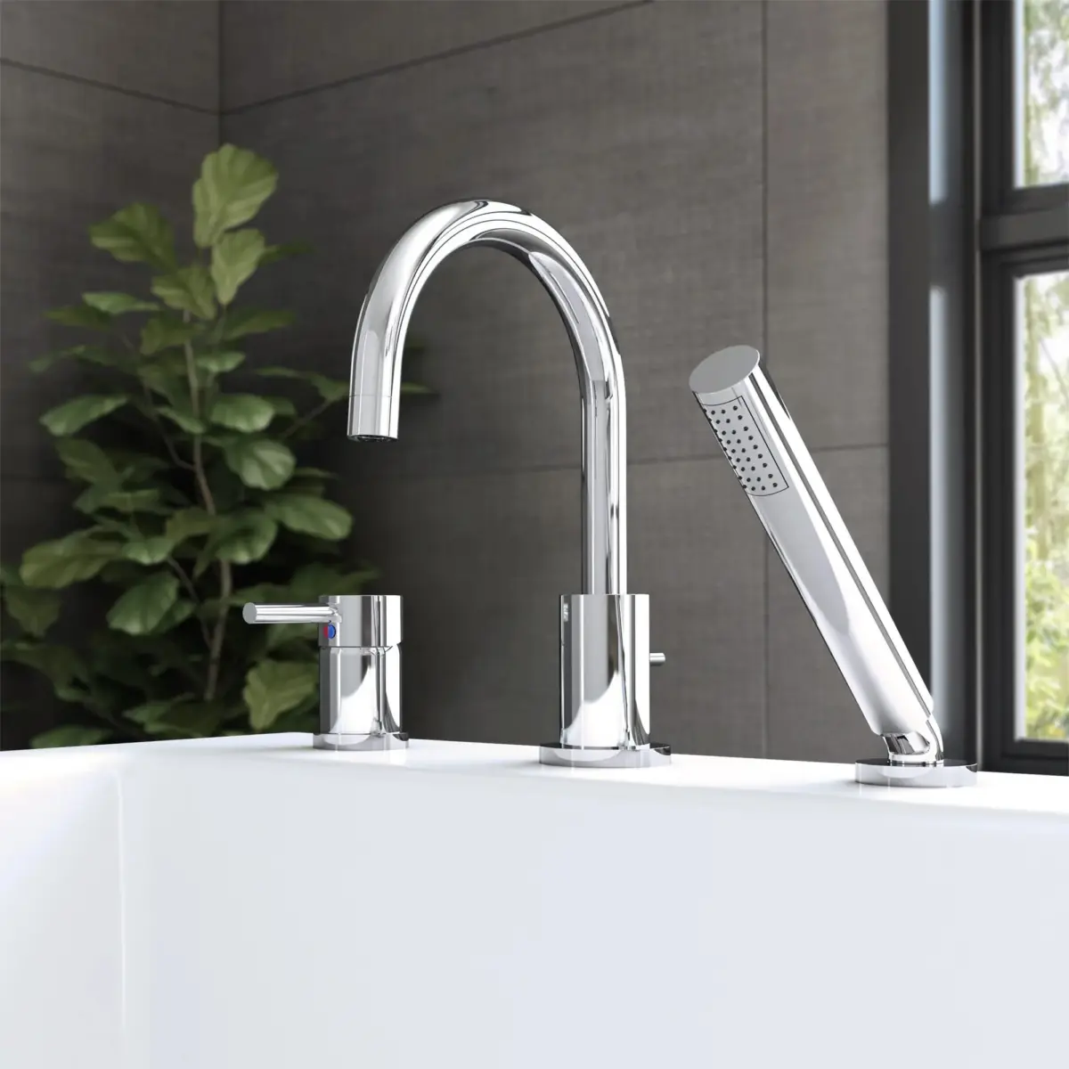 Modern chrome bathroom faucet with single lever handle and handheld showerhead next to a white bathtub.