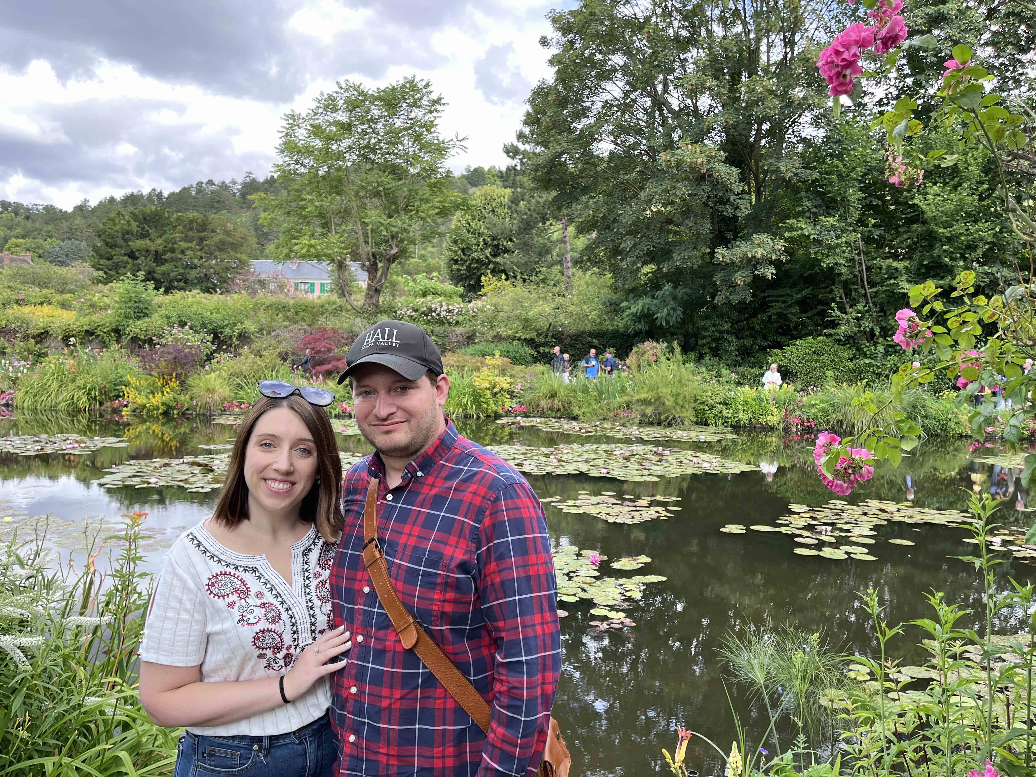 A couple standing in front of a pond