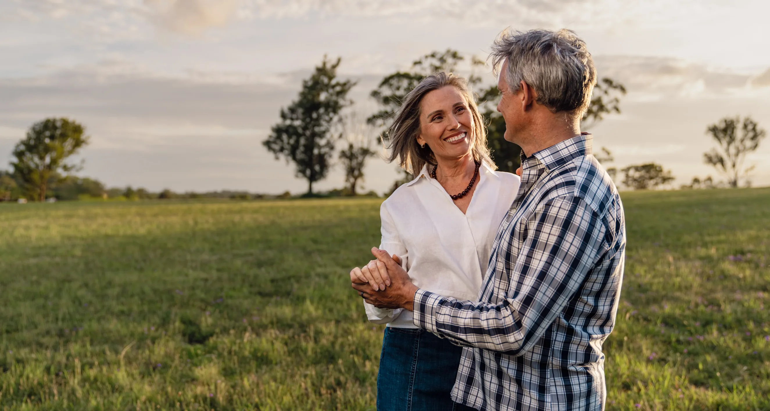 A couple dancing in a field