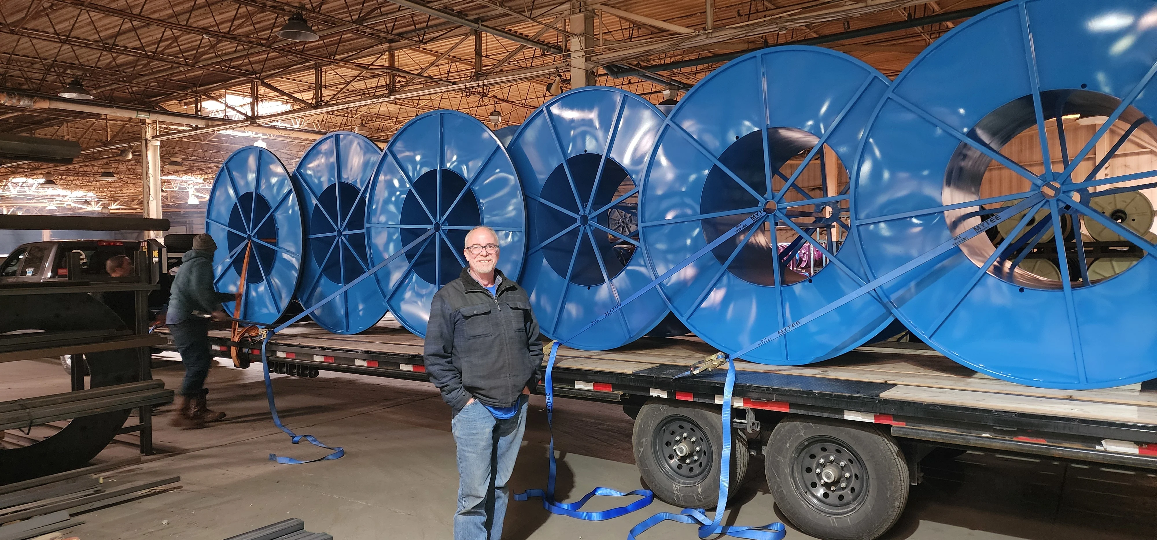 Industrial reel manufacturing facility with experienced technicians working on steel wire reel reconditioning and repair services#1.6