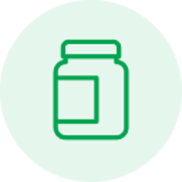 Green line icon of a medicine or vitamin bottle on a pale green circular background.