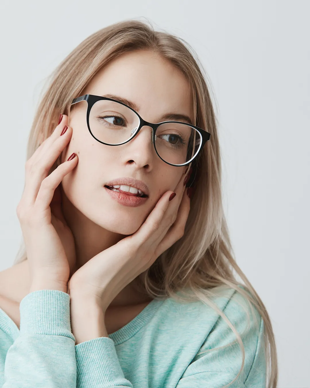 Woman wearing stylish black prescription glasses with quality spectacle lenses from opticians