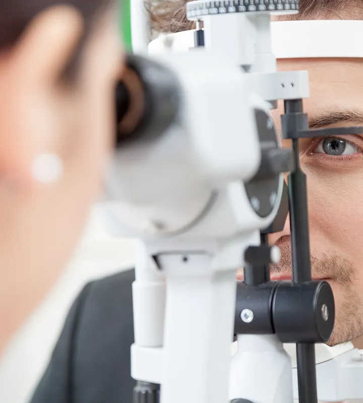 Professional optometrist performing comprehensive eye examination using slit lamp equipment