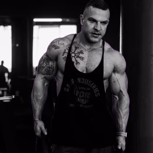 Muscular athlete standing in a gym during focused strength training