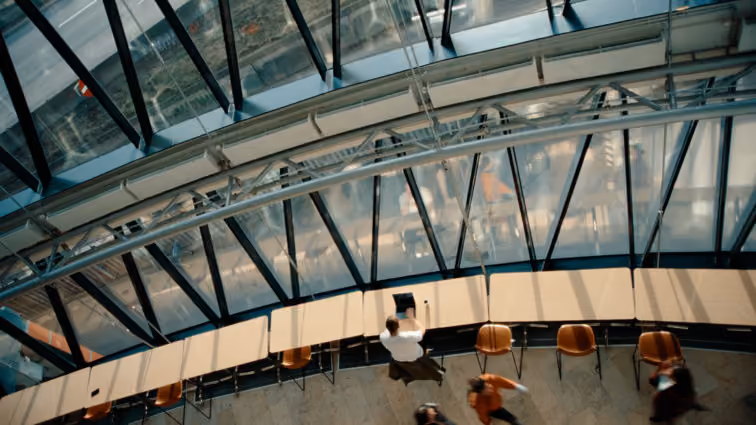 A bird's eye view of the large windows at the front of Visma House in Oslo.