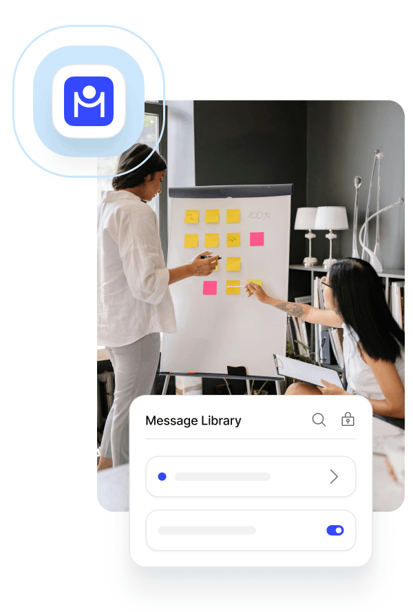 Two women organizing colorful sticky notes on a whiteboard during a meeting.