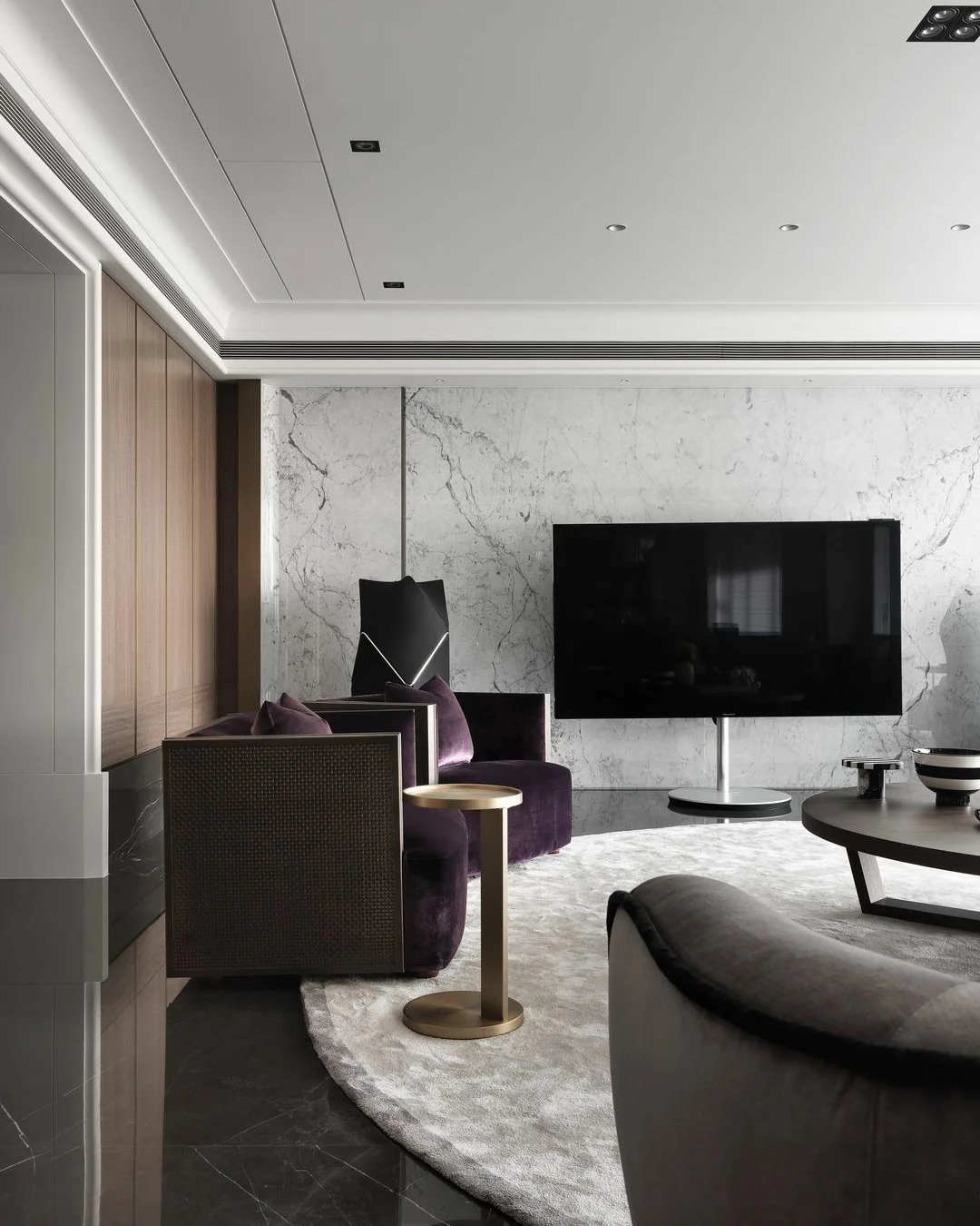 珥本設計|寶輝秋紅谷客廳電視牆:白色 Carrara 大理石牆面配 Bang & Olufsen 黑色立式喇叭,搭配 PROMEMORIA 紫色絨布扶手椅與黃銅圓邊几。