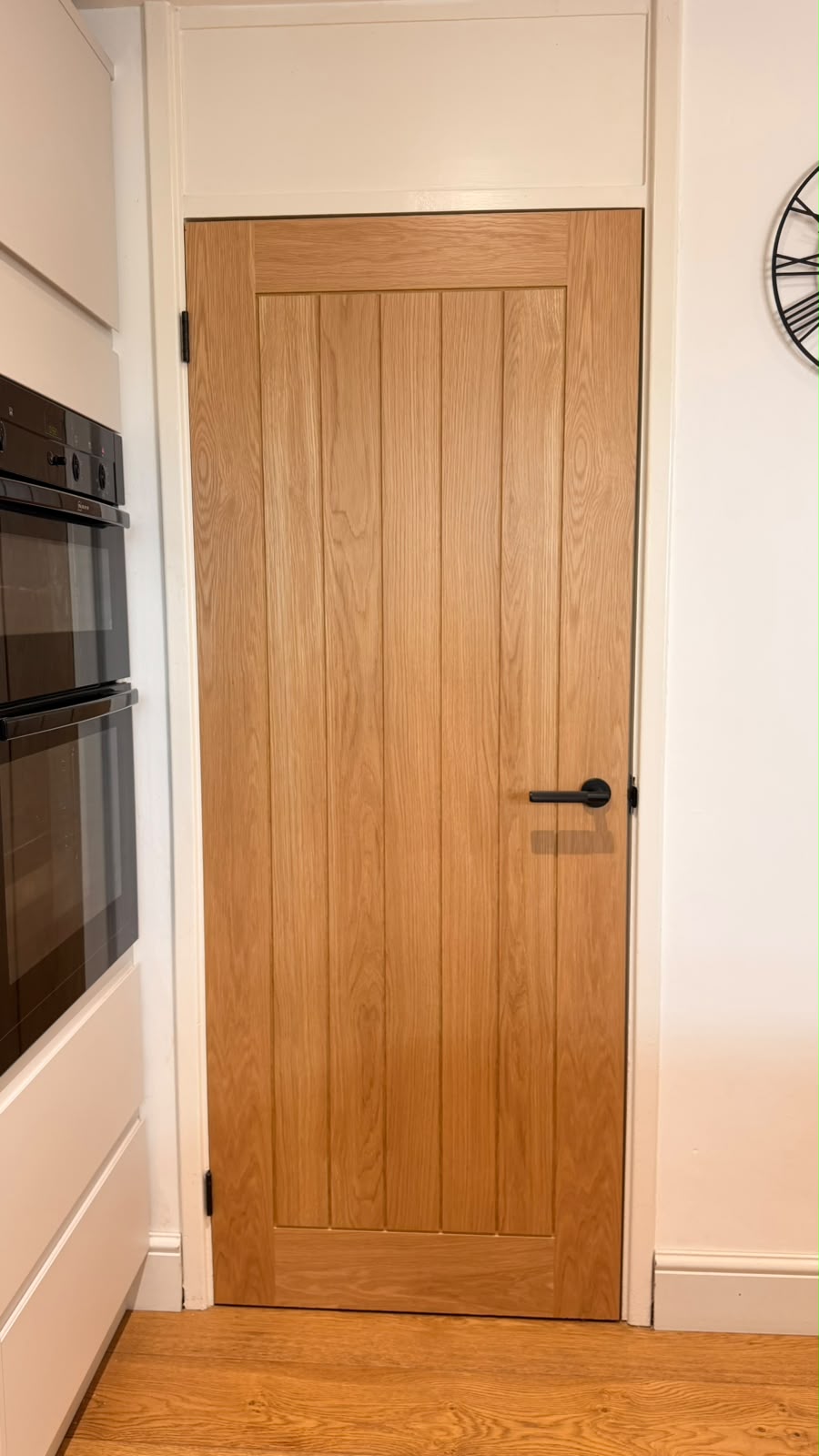 Fully finished oak cottage internal door beside kitchen cabinets in Bordon