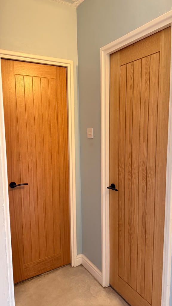 Holdenby Oak internal doors with vertical panelling in a carpeted Woking hallway
