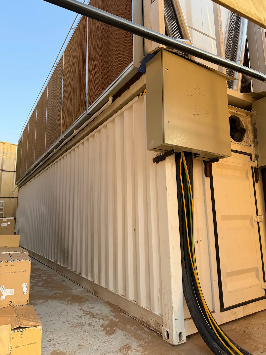 Mining container with evaporative cooling panels and electrical connections at a Pure Mining facility