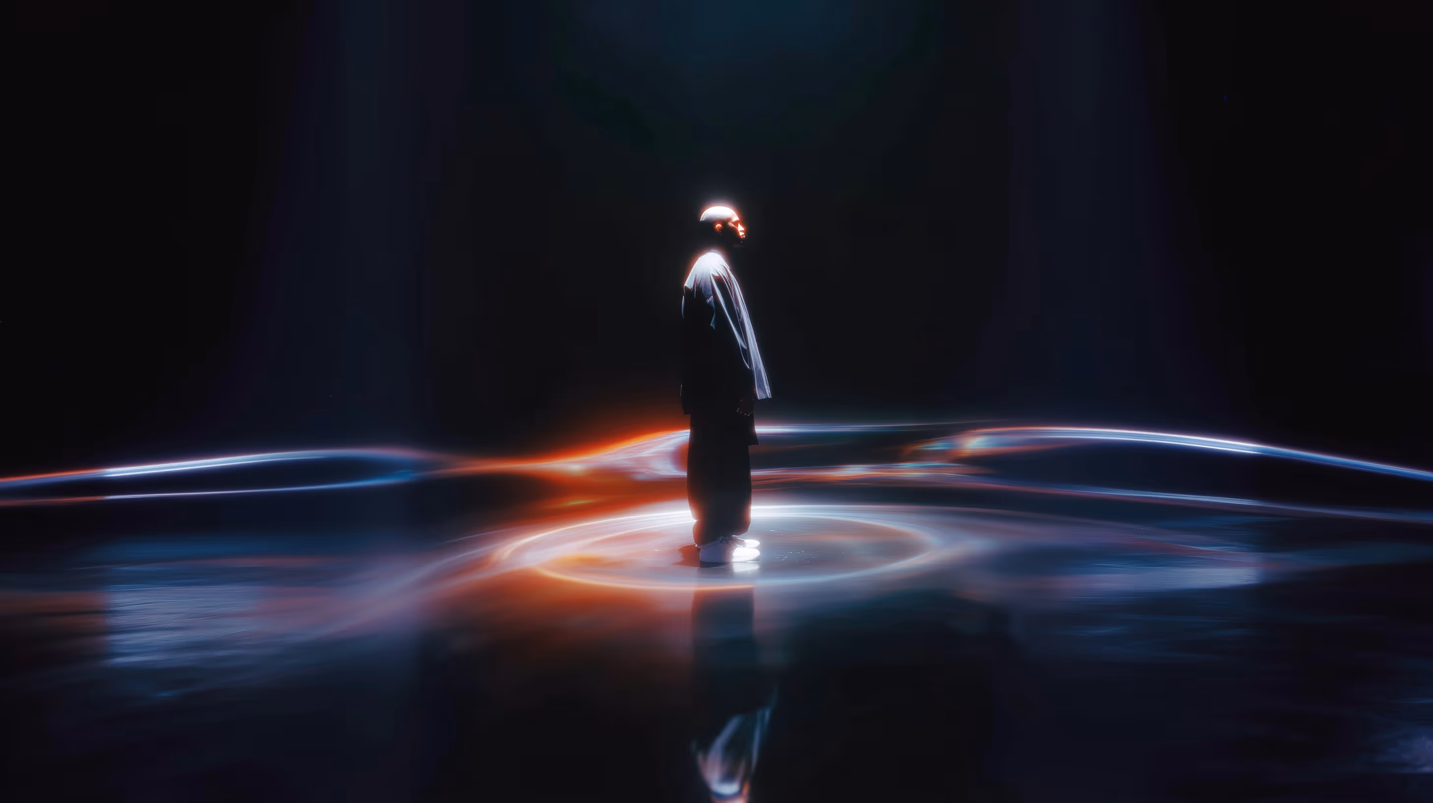 A man standing in the middle of a dark room.