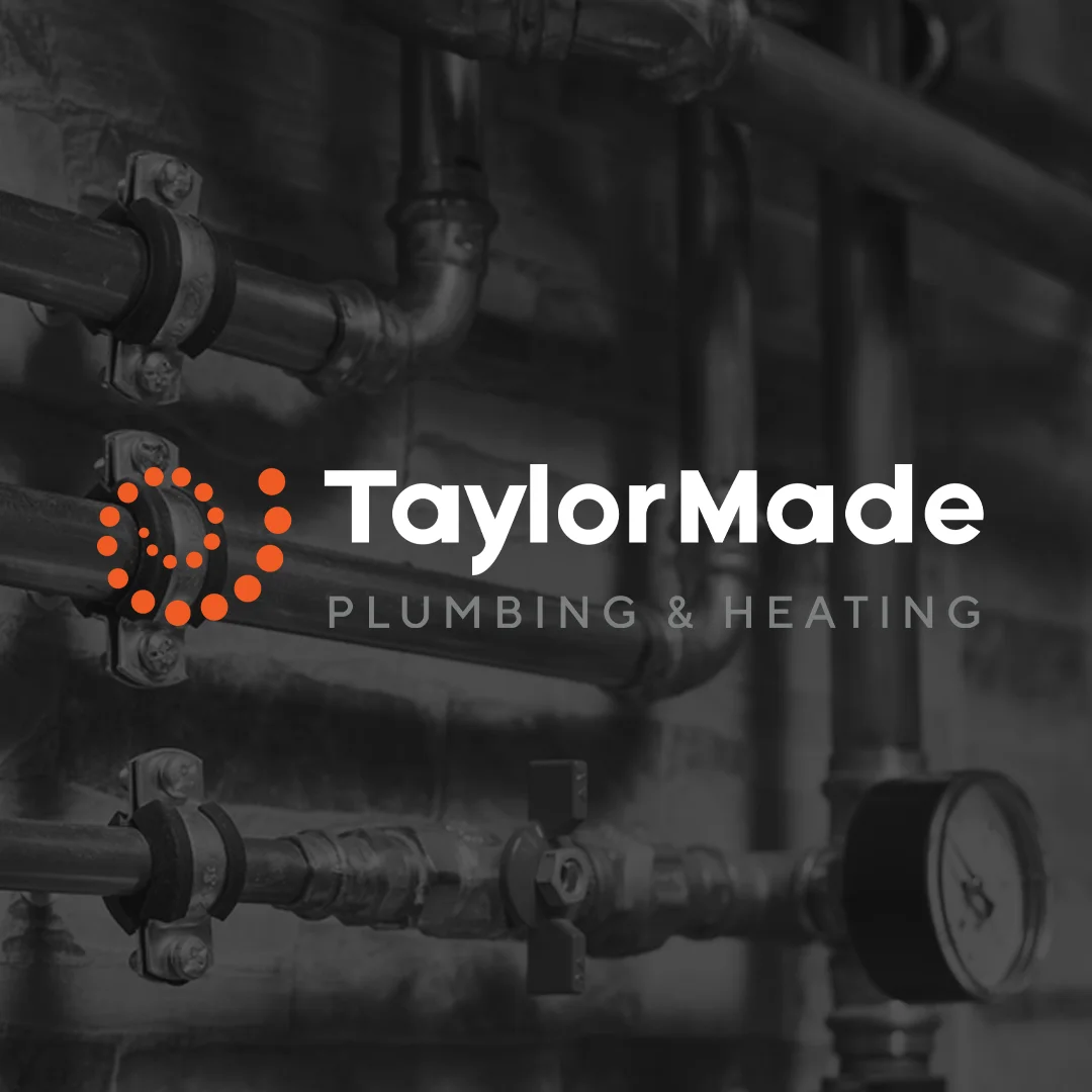 TaylorMade Plumbing & Heating logo over black and white image of plumbing pipes and a pressure gauge.