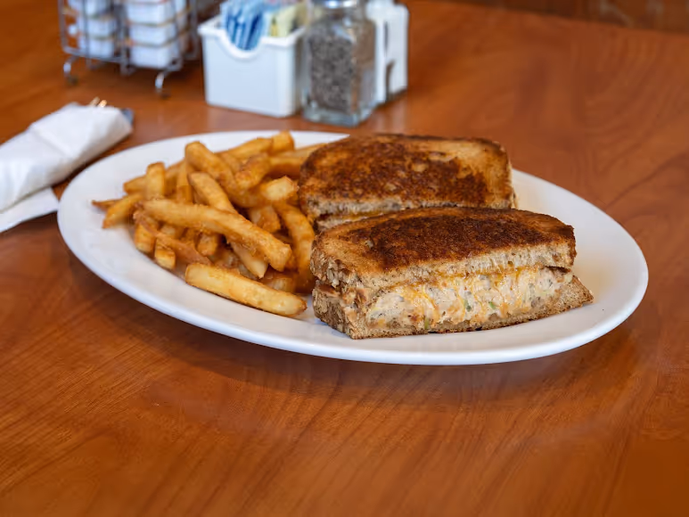 A plate of food with a sandwich and fries.