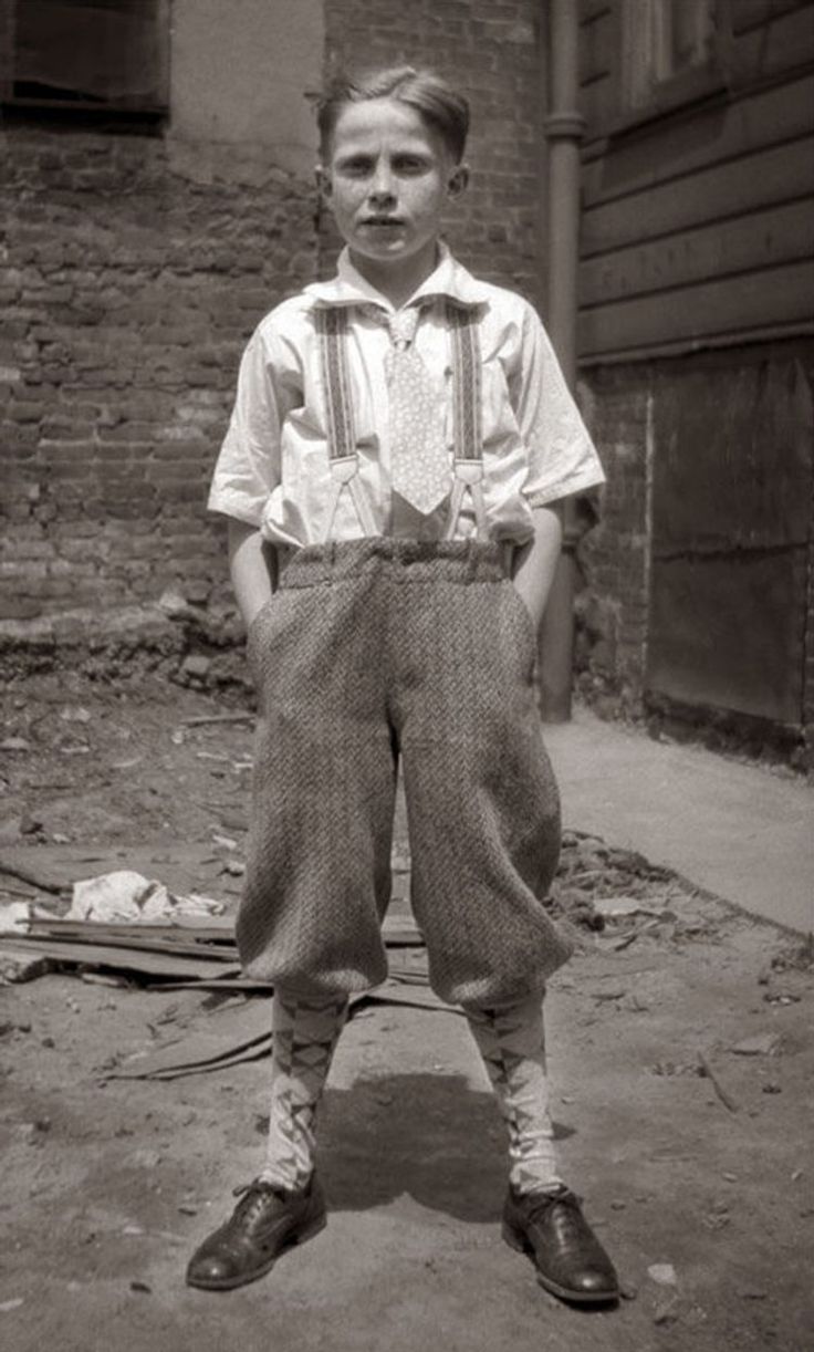 a picture of a young boy in black in white (probably the 1920's)