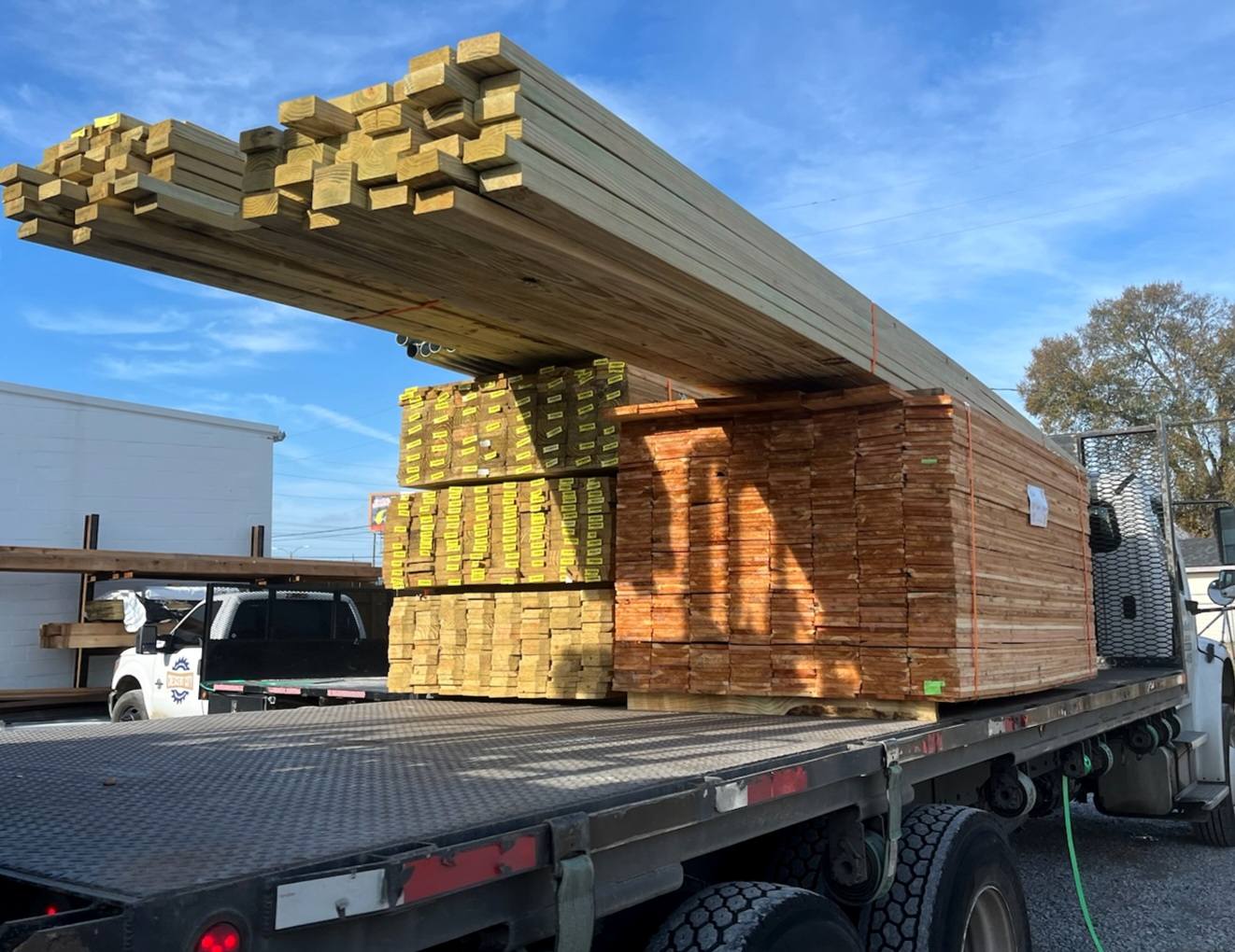 lumber stacked on back  of truck