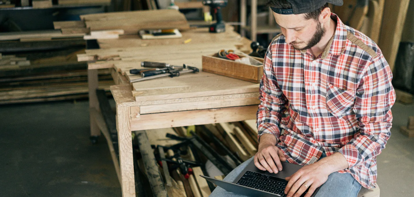 Chef d’entreprise de PME consultant ses outils numériques en atelier