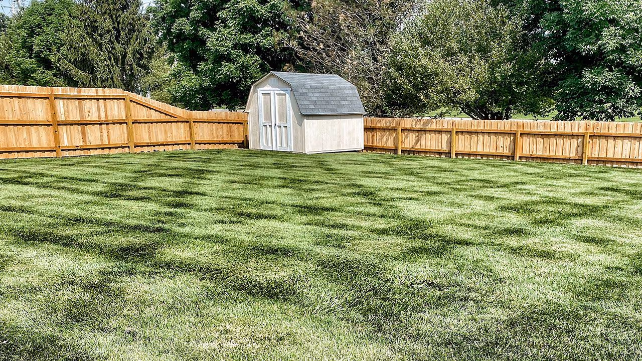 Clean striped lawn after mowing by Gould Brothers Outdoor Solutions LLC