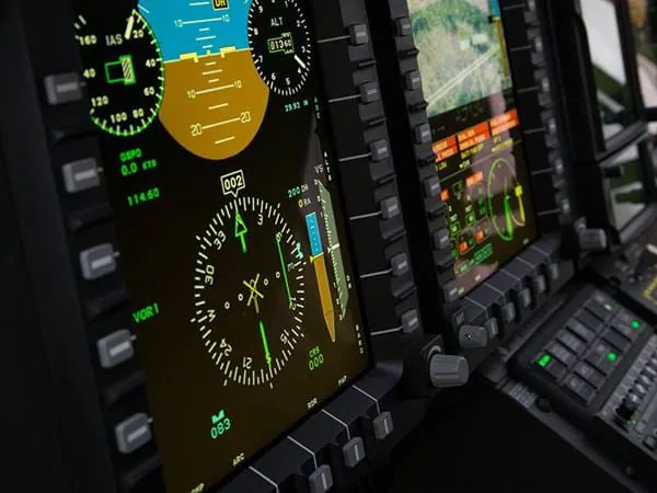 Cockpit display screens showing flight data, navigation, and altitude information.