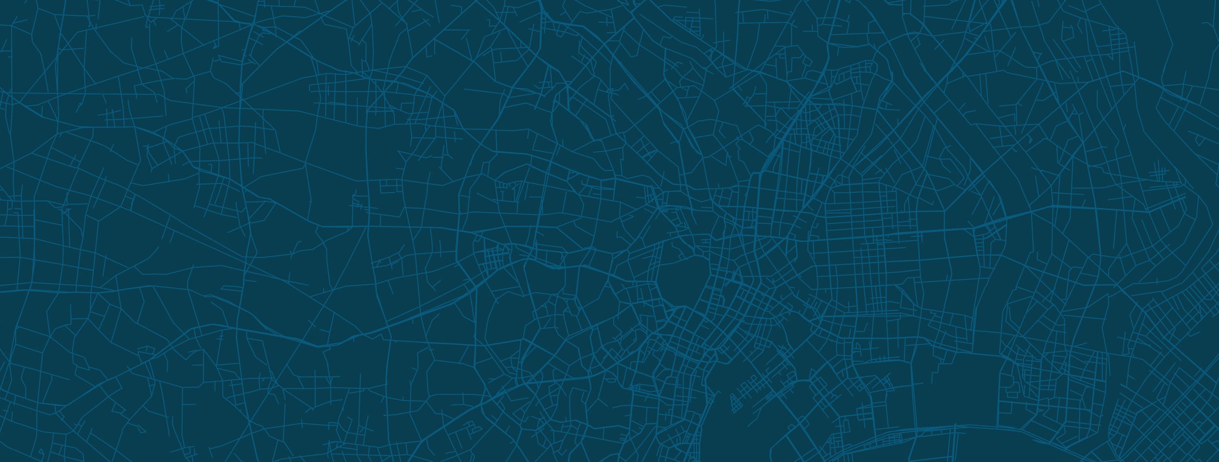 Detailed map of a city with a dark background and light blue street lines.