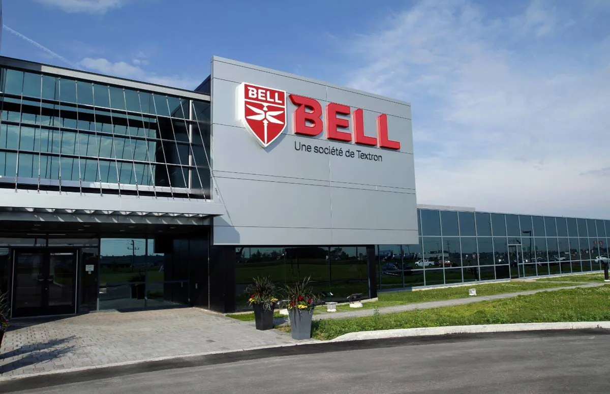 Bell headquarters building with a modern design, featuring a large red logo and glass facade.