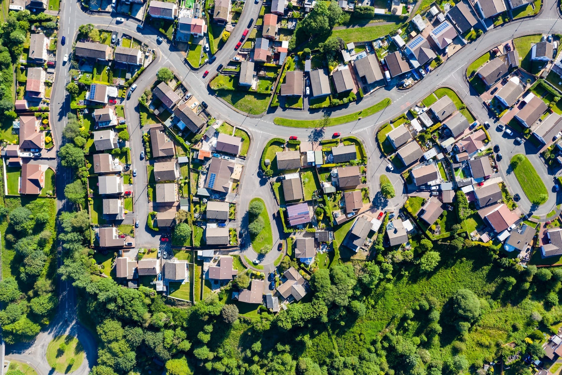 Aerial view of a residential neighborhood with curved streets and greenery.